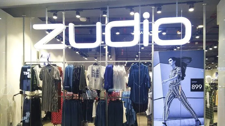 How Zudio Became a Top Fashion Brand Without Selling Online 2 a Zudiostore with a sign and a woman on the wall